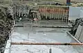 下庄地区内の川幅の広い基幹水路が、右側から手前に直角に曲がっている荒れた水路を掘り下げて、大規模な改修工事中の風景。(2014年4月19日撮影)