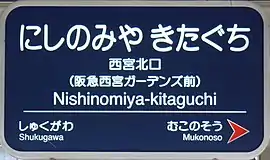 3. 阪急電鉄の駅名標の例(阪急西宮ガーデンズ開業後の西宮北口駅)。2.とフォントや英字表記などが異なる。矢印もホームの進行方向のみの記載になった。