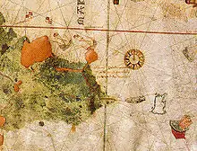 手書きの古地図。紙幅の右側には大きな羅針図、左側には海岸線が描かれ、中央に説明書きがある。