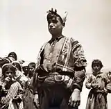Adolescent boy standing in front of younger children