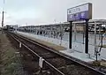 ロータリー入口の踏切脇にある駅名表示