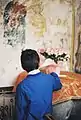 Boy in fromt of mural at Monastery of Saint John's