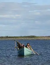 Two men rowing in a canoe.