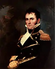 Commodore David Porter in full naval dress sitting in a chair next to a table.