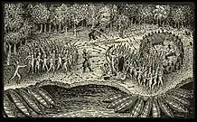 A black and white engraving. Two masses of Native North Americans face each other in the center, firing at each other with bow and arrow. In front of each group there are a number of canoes pulled up against the shore of a body of water. In the background there are trees. Between the two groups stands a single man wearing some sort of armor. He is firing a rifle or musket at the group on the right, and you can see the puff of smoke rising from the weapon. Further back near the trees are two other men who are also firing weapons at the group on the right. There are two wounded individuals lying next to the group on the right.