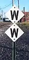 The whistle post sign style of GTW on a double whistle post at Battle Creek, Michigan