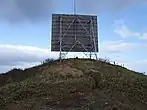 山頂のアンテナ板の下に頂上ケルンが
