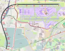 A map of the Heathrow airport area, with a curved solid black line starting from the northern runway and ending southwest of the airfield, near a pond; red numbers from 0 to 150 are marked along the black line.