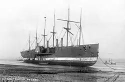 リヴァプールと川を隔てた対岸、ロック・フェリーの浅瀬で解体中のグレート・イースタン（1889年頃）。既に外輪は撤去されている