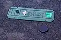 スタートマット。手前は、対比用の52mmフロントキャップ(カメラのレンズキャップ)