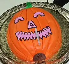 A Halloween cake prepared with the appearance of a jack-o'-lantern
