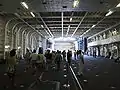 ヘリコプター護衛艦「ひゅうが」のハンガー。後部エレベーターの開口部から光が差し込んでいる。