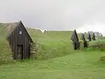 屋根の上に草が生えたKeldurの芝土の小屋