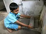インドにて、石皿で穀物を挽いているところ。2011年3月6日(Exifデータより)