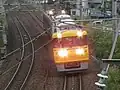検測走行中のDR1編成架線検測のためパンタグラフが上昇し、サーチライトが点灯している。