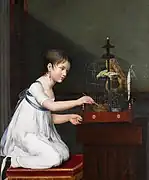 鳥かごを掃除する少女