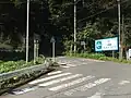 県道521号との交点（相模原市緑区佐野川字上河原、上河原バス停付近）。左方向へ向かい和田峠方面から来た県道521号と重複する。