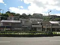 「家は田中町に移った。重砲兵連隊のすぐ前に餅屋を出した。父が足踏みの餅つき器を踏み、母は石臼にしゃがむ。餅とり粉で真白な板の台に搗き上った餅が移される。そこには祖母が待っている。父の役目はそこまでだった」
