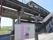 川辺宿駅の地上入口金田一耕助の看板に「ミステリー遊歩道起点」と記されている。