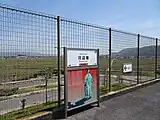 「川辺宿」の駅名標駅名標の下に金田一耕助が描かれている。