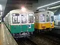 瓦町にて並ぶ緑色の長尾線列車と黄色の琴平線列車。（2007年）
