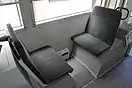 客室座席。左からクロスシート部分・ロングシート部分・折りたたみ座席部分。左のみ2次車 (9703)、他2枚は3次車 (9704) で撮影。（2016年）