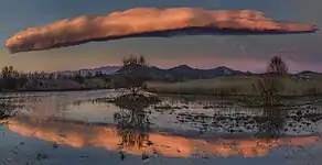 山脈に平行に伸びるロール状のレンズ雲