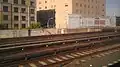 A crumbling platform with the stairs removed on the northeast side of the LIRR main line.