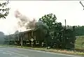 標準軌貨車を搭載したロールワーゲンを牽引する9951-60形、オーシャッツ駅付近、1991年