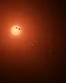 当時描かれた、TRAPPIST-1と、その周りを巡る7個の惑星の想像図