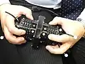ウダー。遠目に見ると、楽器の構え方がコンサーティーナと少し似ている。新開発の電子楽器。