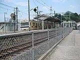 市道から広島方面を見たホーム。右側に少し見える建物が駅舎(2009年8月)