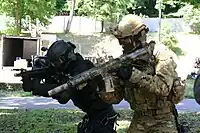 サプレッサーを装着、全体に迷彩塗装を施したHK416を使用するポーランド軍特殊部隊GROMの隊員