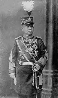 陸軍の儀礼用の第一種帽(シャコー帽)を被る明治期の士官。モデルは久邇宮邦彦王。
