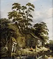 川辺の小屋と人物