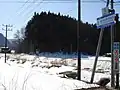 郡山市湖南町赤津の道標と風車。(平成19年2月)