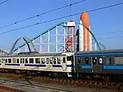 駅に到着する普通列車。背後は、スペースワールドのジェットコースター「ヴィーナスGP」(2005年9月)