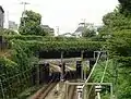 井の頭線を跨ぐ水道橋（2015年9月）線路右側の水道橋下の空き地は東京山手急行電鉄の建設予定地跡