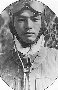 第二種航空服(鷲見忠男)。第二種航空頭巾の耳宛部分のレシーバーからはコード(電纜)が伸びており、これを機内の無線機に接続する