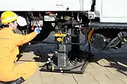 軌陸車を道路から線路に移す実演。軌陸車中央のジャッキで車体を持ち上げる。
