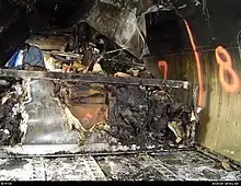 Burned cargo and cargo containers inside the cargo compartment of an aircraft.