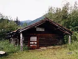The log-built post office at Wiseman, seen here in 1995, has been sinking into the ground for the past century, and is now a couple feet below ground.