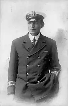 Man in dark naval uniform and wearing an officer's cap